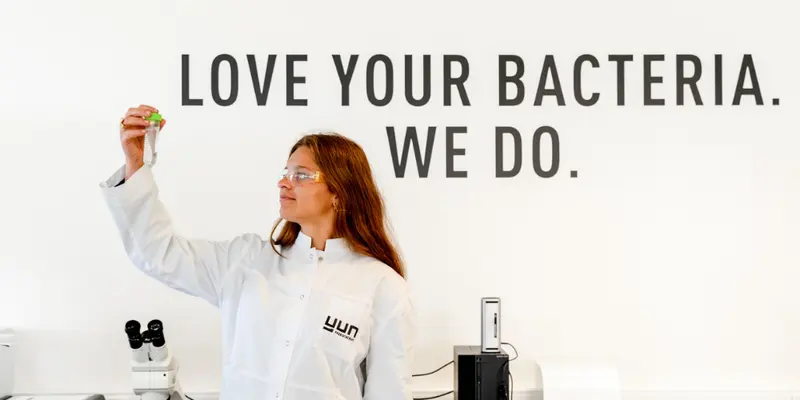 นักวิทยาศาสตร์ของ YUN ในห้องปฏิบัติการ ใต้ข้อความ Love your bacteria